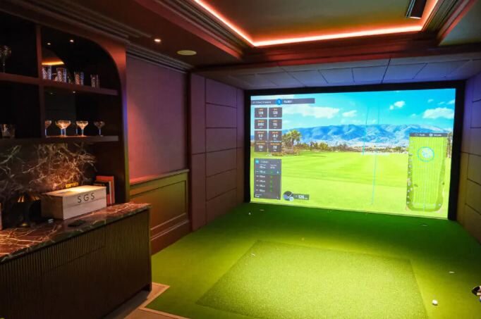 Bespoke simulator bay with bar shelving and warm lighting
