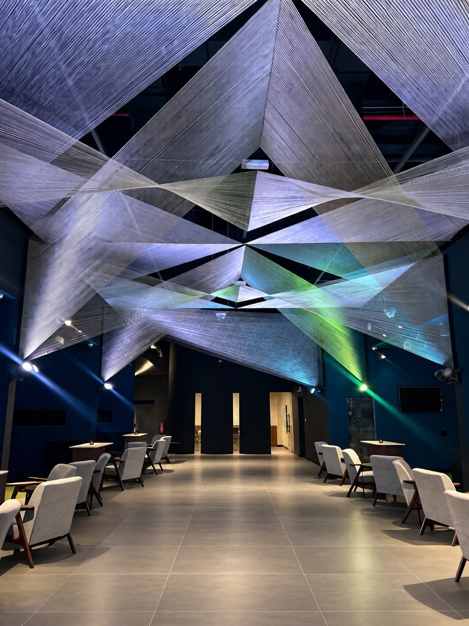 Lounge under a sculptural string ceiling at Five Iron Golf Yas Bay, Abu Dhabi