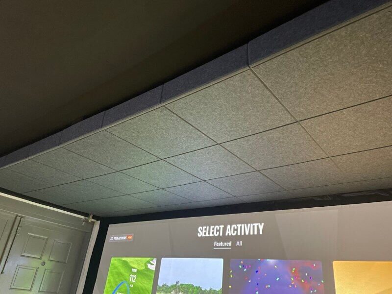 Grey acoustic tiles on a simulator room ceiling