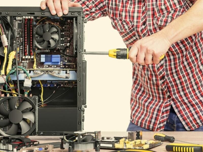Technician servicing the inside of a desktop PC